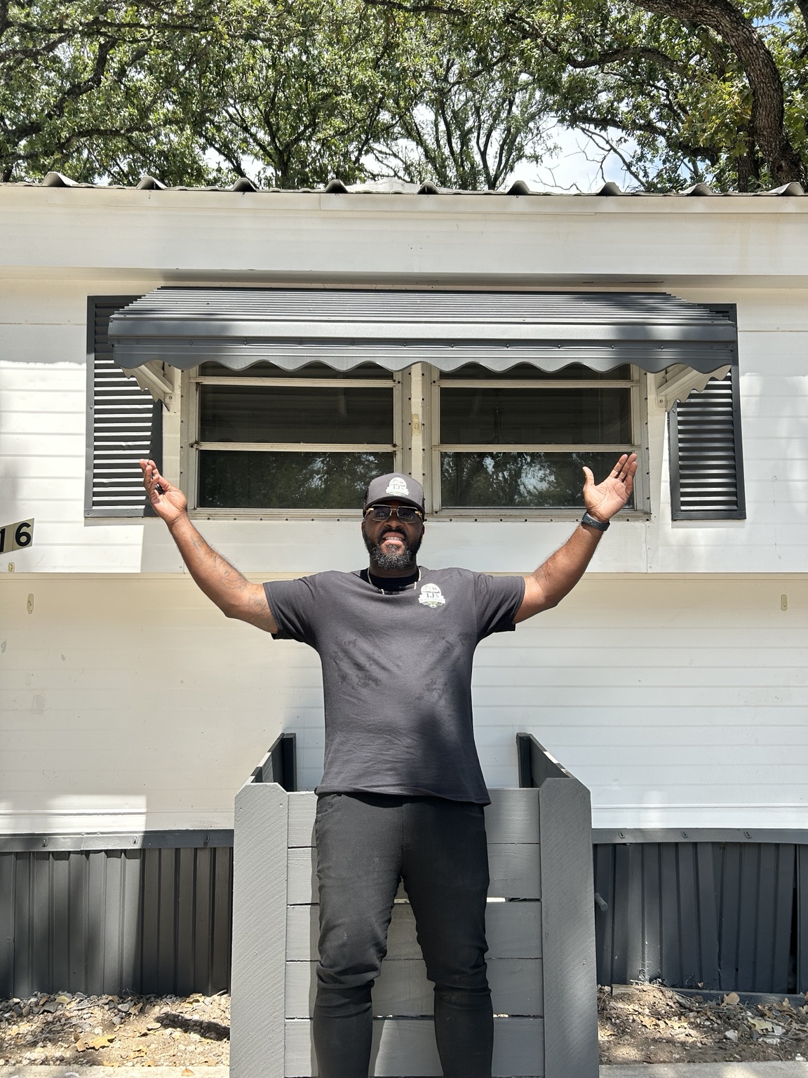 IJ’s Wheel Estates founder standing in front of a renovated manufactured home in DFW